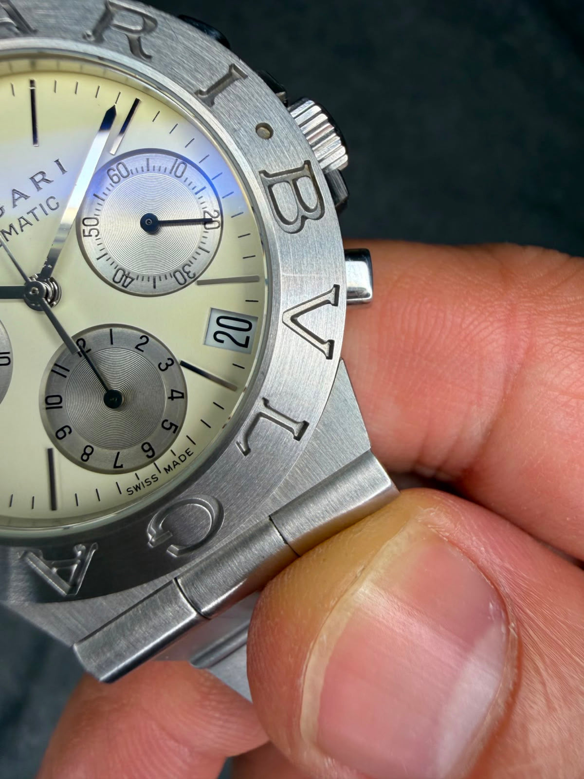 Macro detail of the ivory dial, silvered chronograph registers, date window and SWISS MADE marking