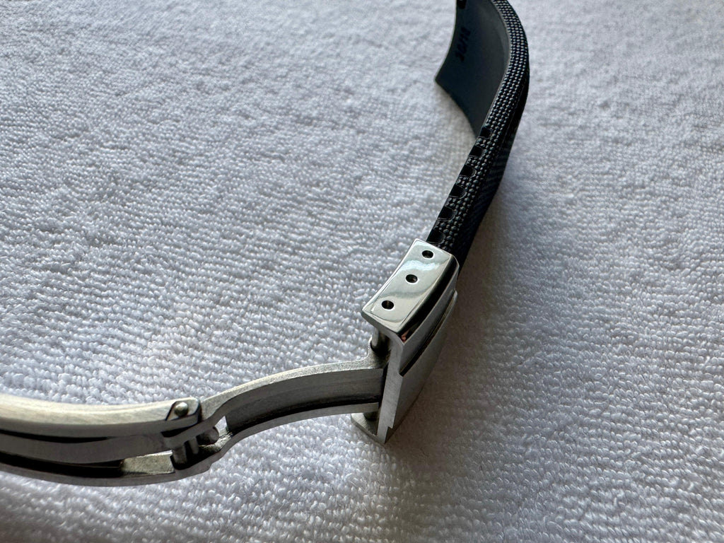 Black textured rubber watch strap with stainless steel folding deployant clasp